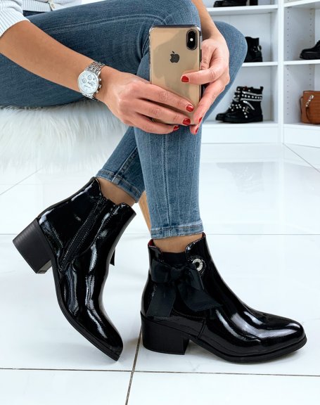 Black patent leather ankle boots with integrated bow