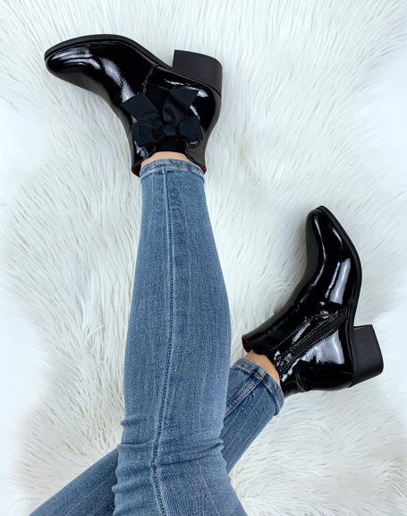 Black patent leather ankle boots with integrated bow