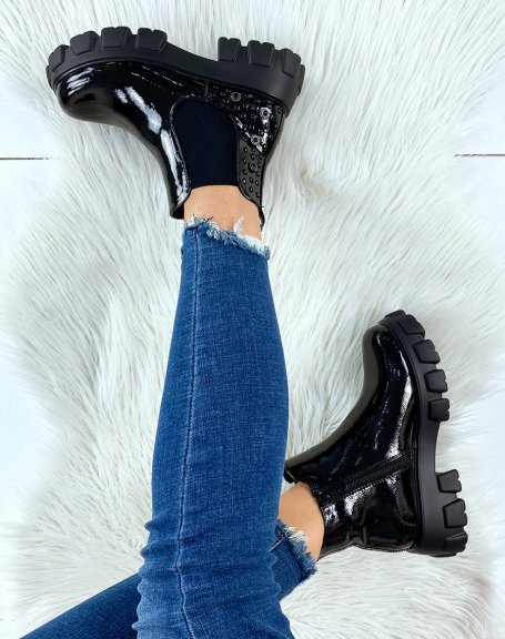 Black patent leather Chelsea boots with embellishments and notched soles