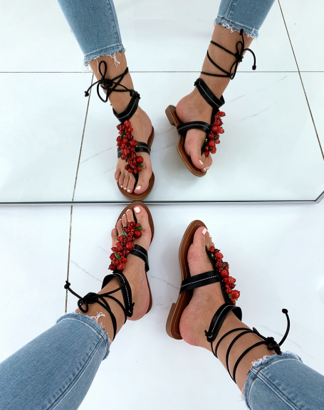 Black sandals decorated with red pearls