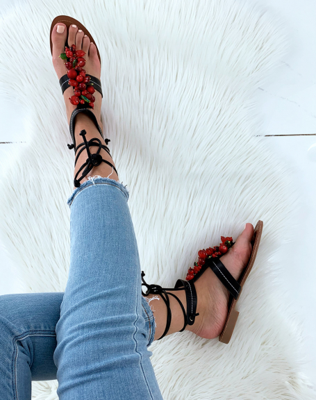 Black sandals decorated with red pearls