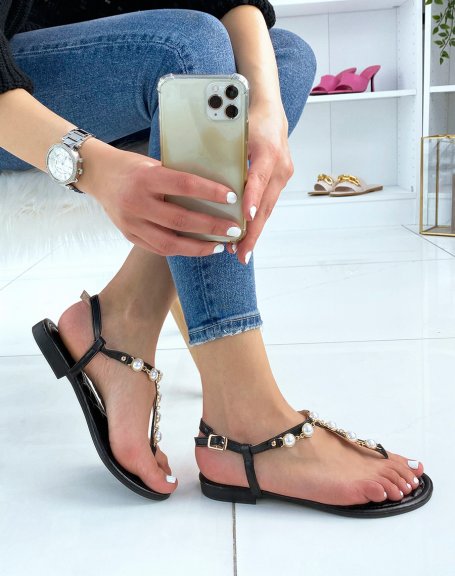Black sandals decorated with white pearls