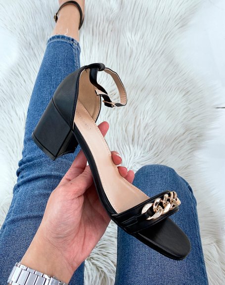 Black sandals with a small chunky heel and golden chain