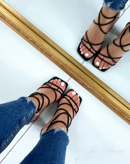 Black sandals with criss-cross straps and rounded heel