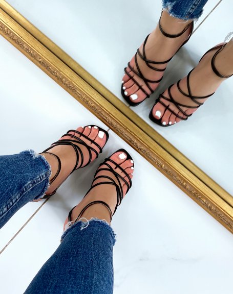 Black sandals with criss-cross straps and thick heel