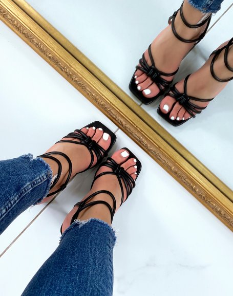 Black sandals with high straps and tied heel