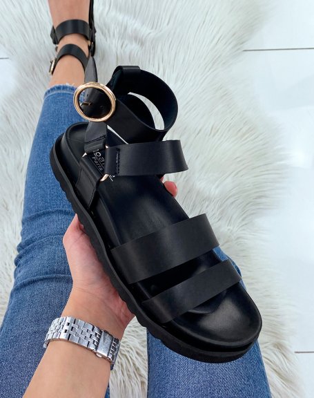 Black sandals with multiple straps and golden buckles