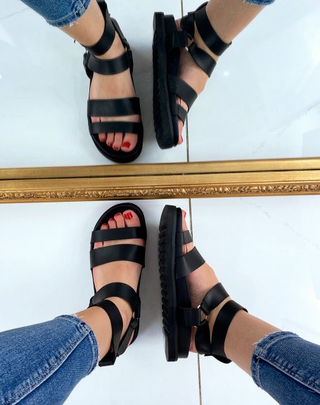 Black sandals with multiple straps and golden buckles