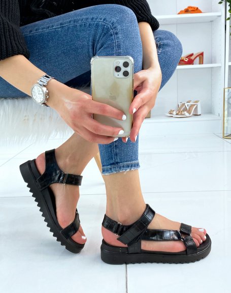 Black sandals with notched sole and asymmetric straps