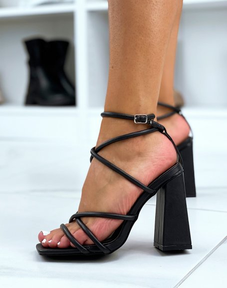 Black sandals with square heels and thin crisscrossing straps