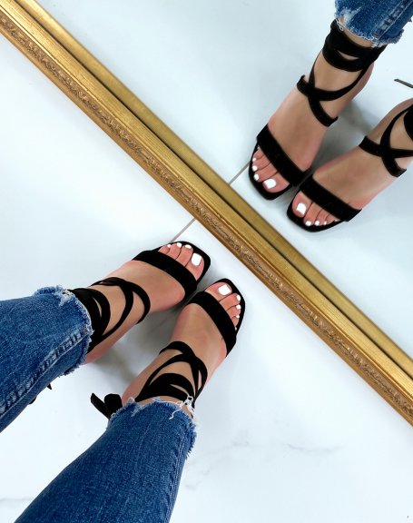 Black sandals with thick strap and long heeled laces