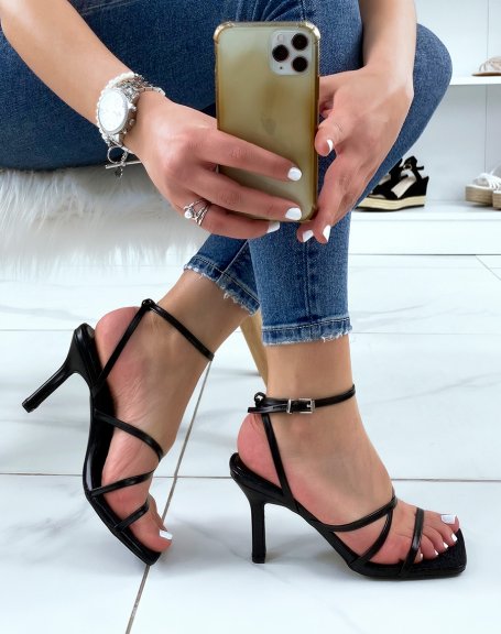 Black sandals with thin strap and burlap interior and stiletto heel
