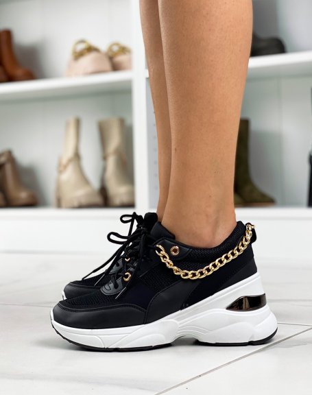 Black sneakers with white sole and gold chain