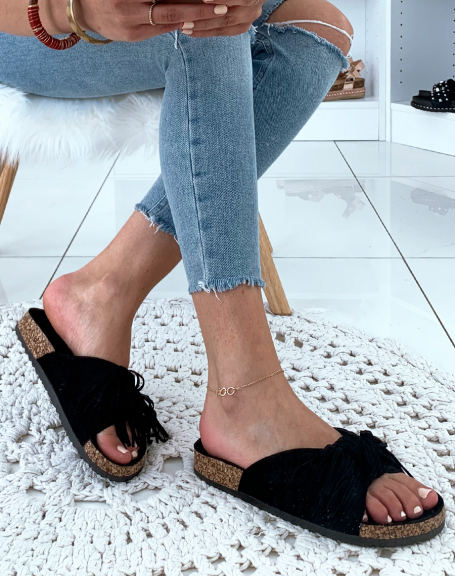 Black suede mules with wide knotted straps and fringes