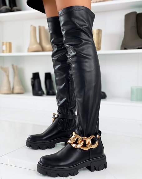 Black thigh-high boots with big gold chain and notched sole