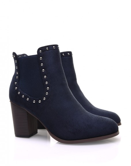 Blue Chelsea boots adorned with studs and heels
