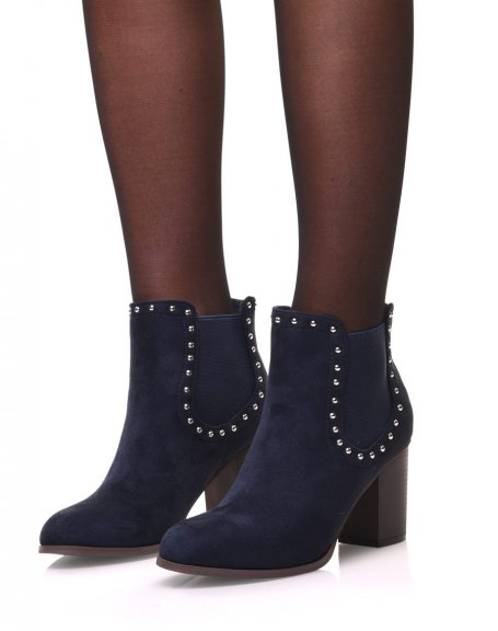 Blue Chelsea boots adorned with studs and heels