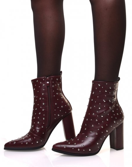 Burgundy high-heeled ankle boots adorned with round studs