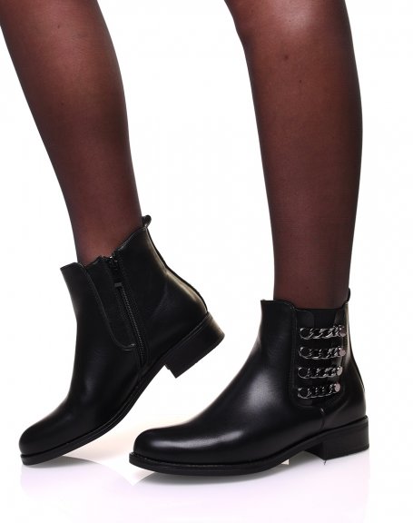 Flat ankle boots with metallic chains on the side