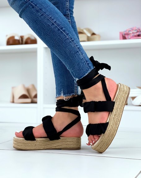 Flat black wedge sandals with pleated straps