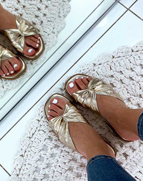 Flat golden sandals with crisscrossed straps