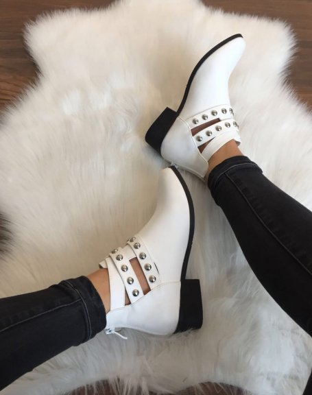 Flat white ankle boots with different studded straps