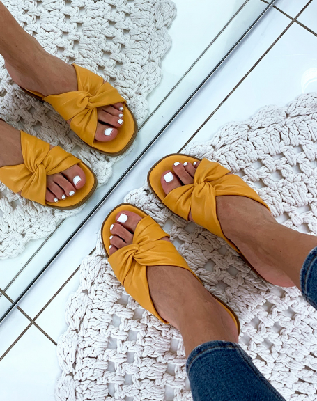 Flat yellow sandals with twisted straps