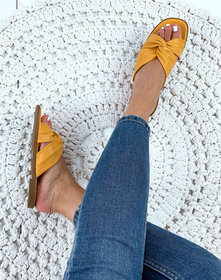 Flat yellow sandals with twisted straps