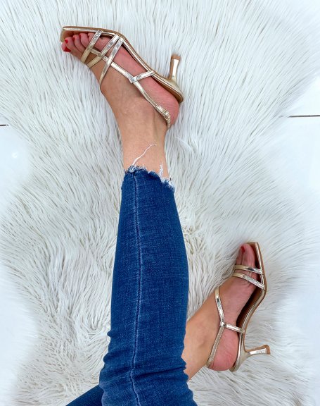 Gold sandals with a small thin heel and crossed straps