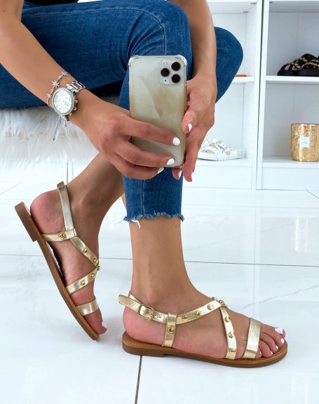 Gold sandals with multiple straps and studded details