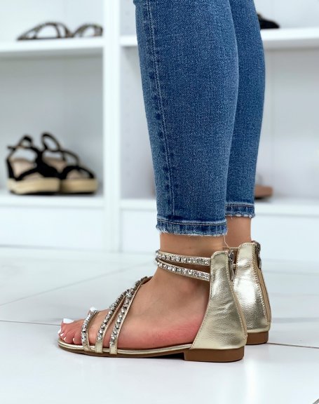 Gold sandals with rhinestone straps and zip closure