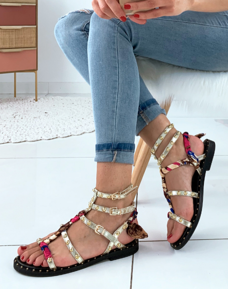 Gold strappy sandals adorned with studs and scarf details
