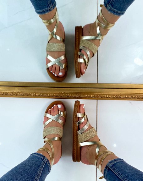 Golden leather slippers with crossed straps