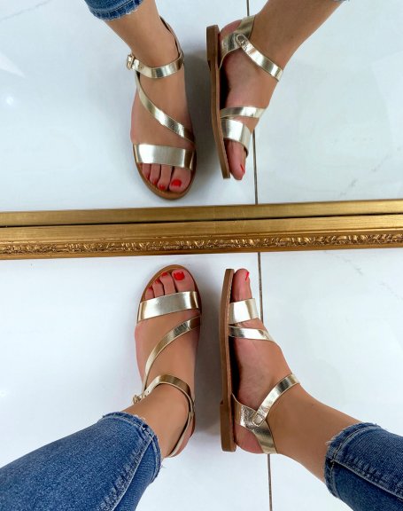 Golden sandals with asymmetrical straps