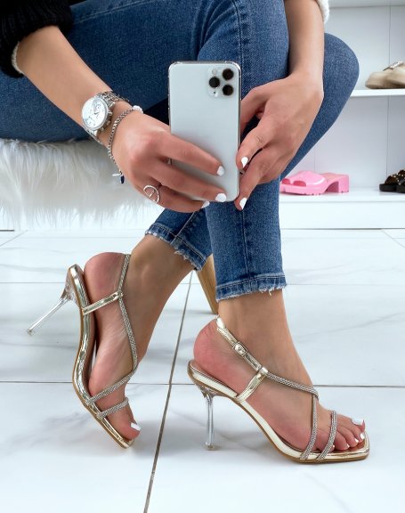 Golden sandals with rhinestones and transparent stiletto heel