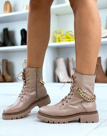 High beige ankle boots adorned with a golden chain