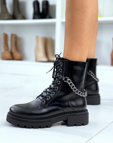 High matt black ankle boots adorned with a gray chain