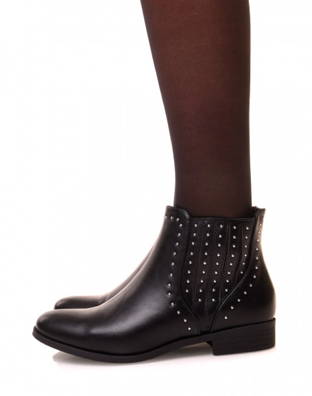 Low black ankle boots adorned with studs
