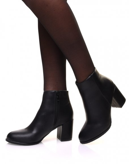 Minimalist black ankle boots with mid high heels