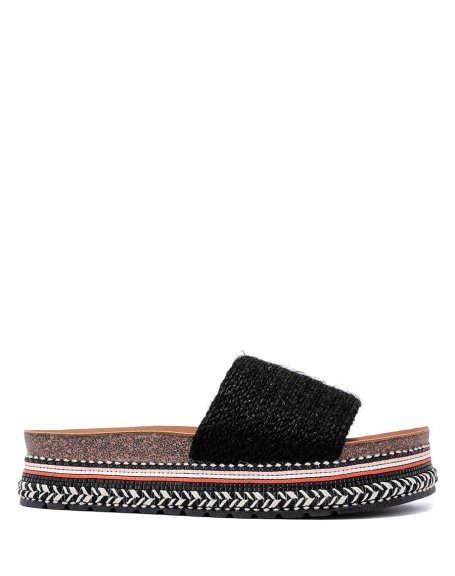 Mules with thick black strap and thick Aztec style sole