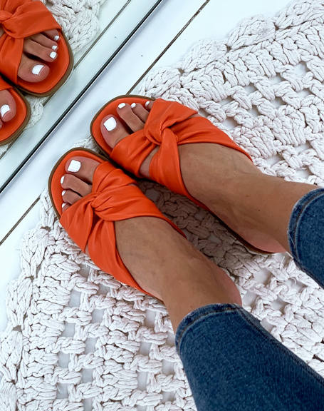 Orange flat sandals with crisscrossed straps