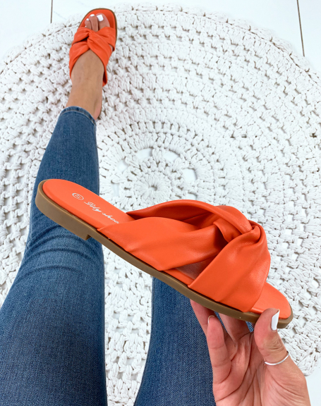 Orange flat sandals with crisscrossed straps