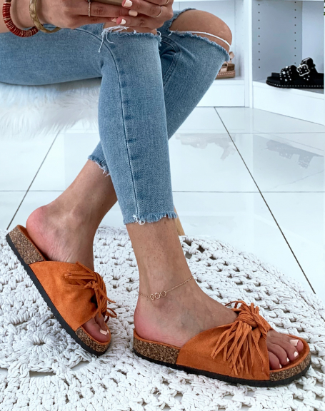 Orange suede mules with wide knotted straps and fringes