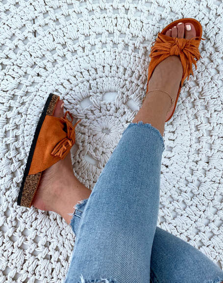 Orange suede mules with wide knotted straps and fringes