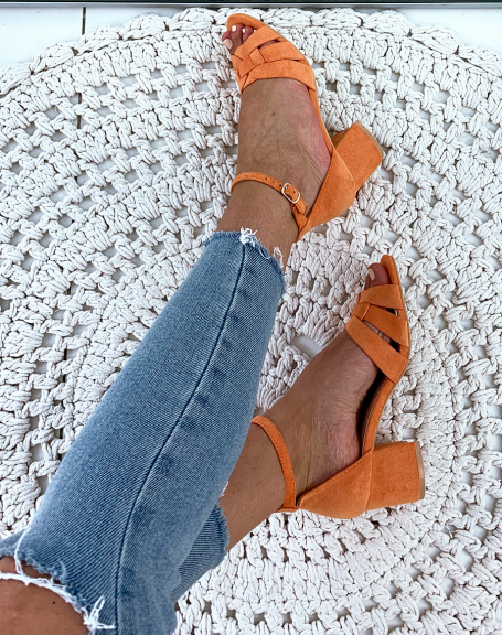Orange suede sandals with small square heels and wide fancy straps
