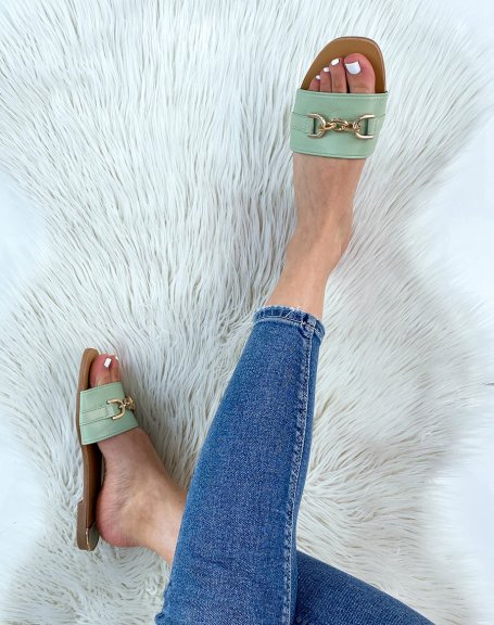 Pastel green mules with wide strap and gold detail