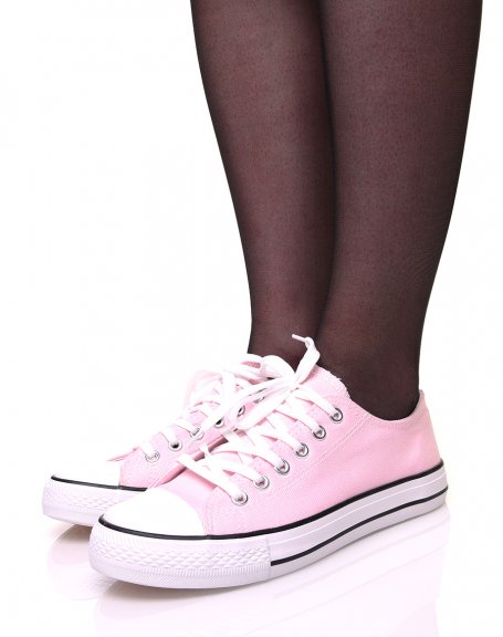 Pink canvas sneakers with white laces and black trims