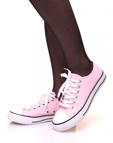 Pink canvas sneakers with white laces and black trims