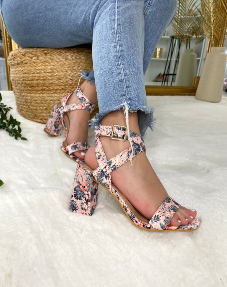Pink heeled sandals with floral patterns and crossed straps