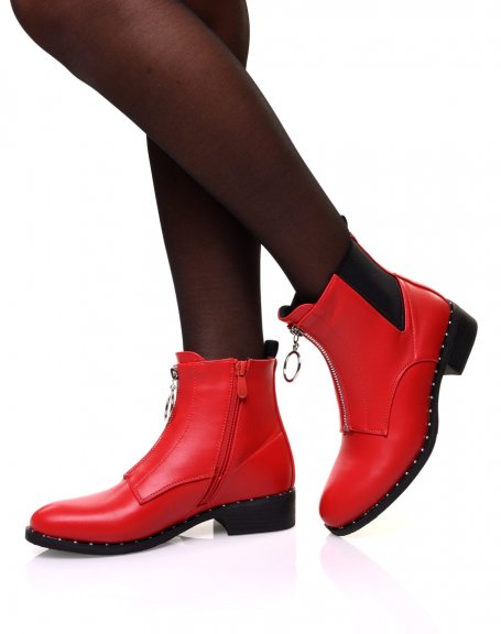 Red ankle boots with studded sole and decorative zipper at the front